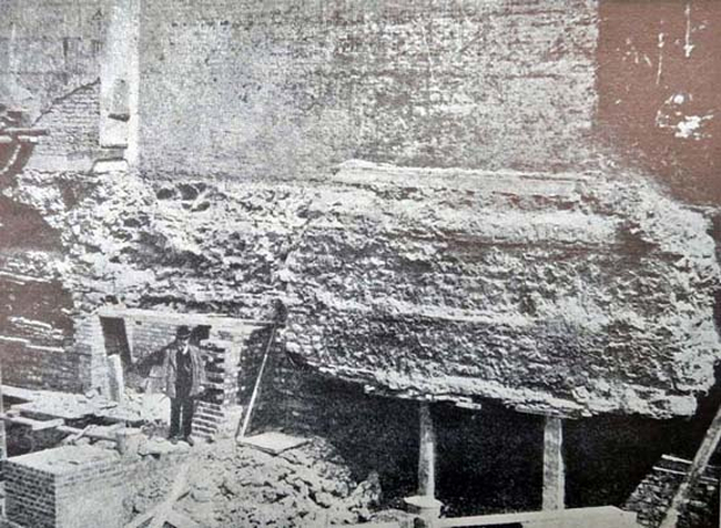View of the undermined internal face of the Roman city wall as exposed during the construction of Roman Wall House in 1905. Photo originally published in Archaeologia, LX
