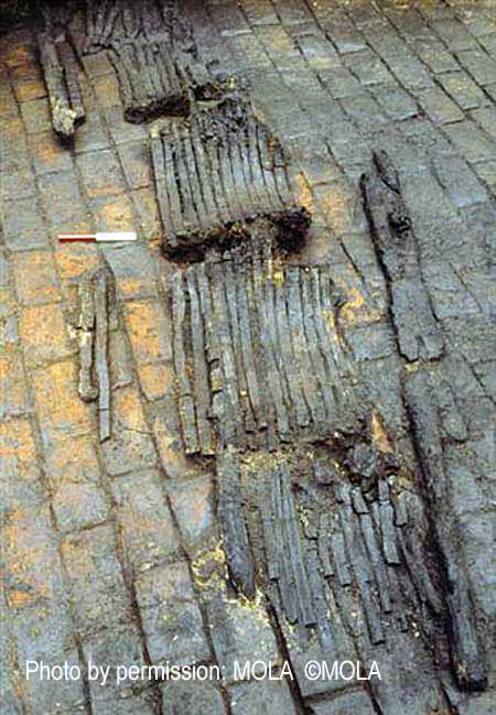 The burnt remains of the wooden barrels on the floor of the Peninsular House (PEN79) cellar